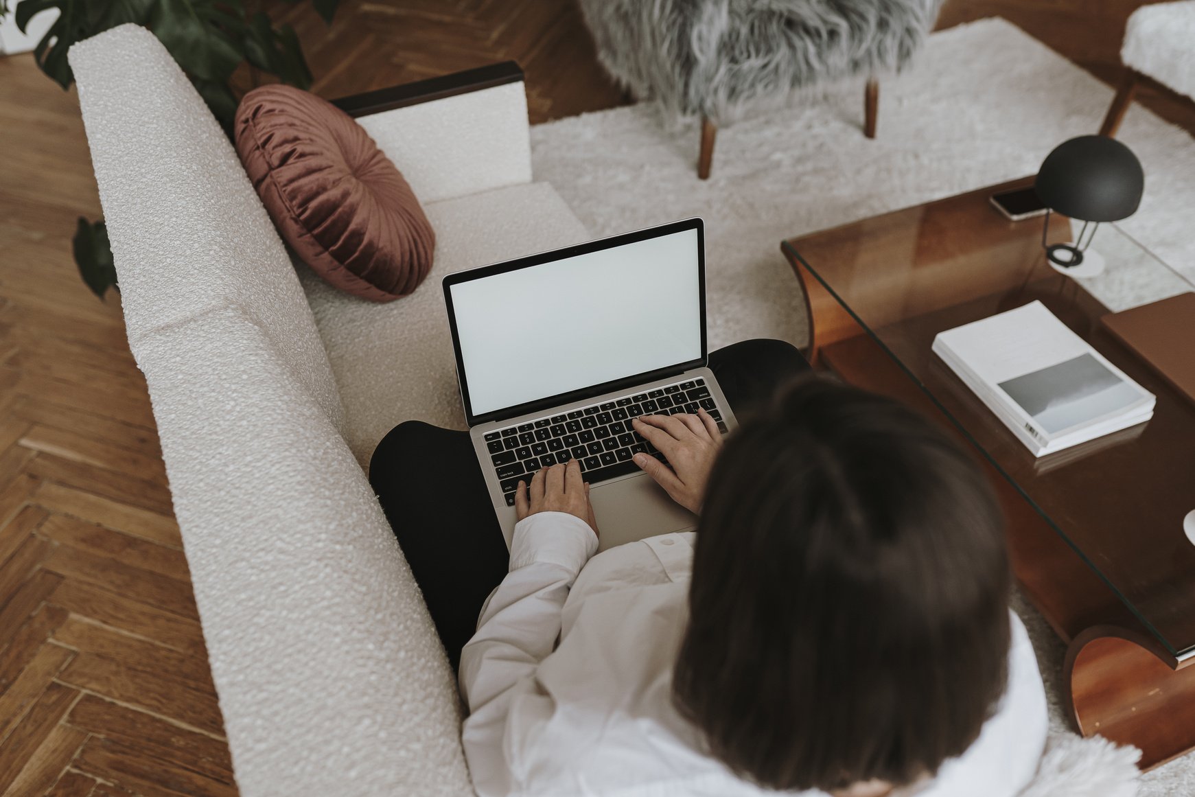 Woman Using Laptop on Couch